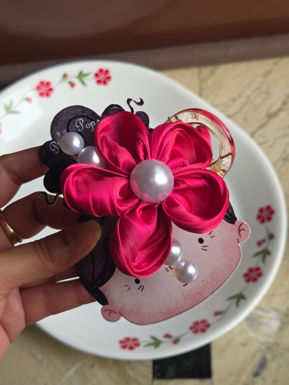 Ruby red satin flower hair claw clip featuring a large faux pearl center and dangling pearl accents.