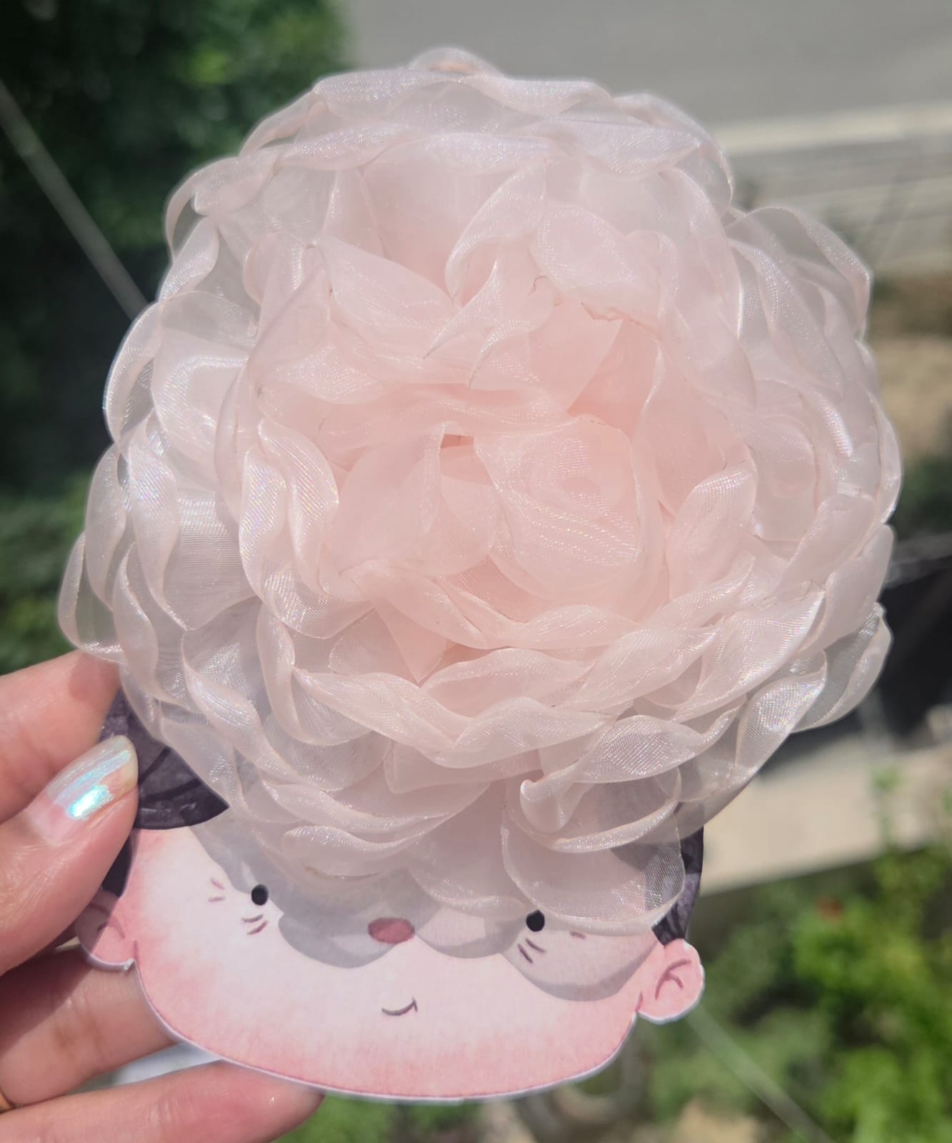Soft blush pink and peach layered organza flower hair clip showing fluffy fabric details