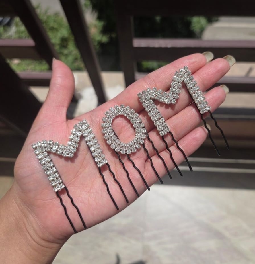 Silver crystal rhinestone MOM hair comb pin held in palm – mama to be baby shower gift