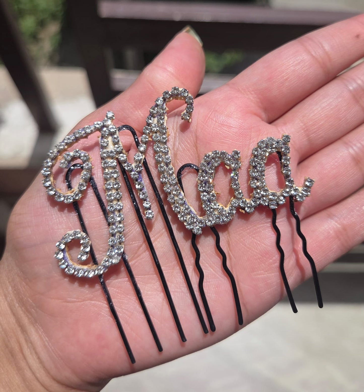 Maa rhinestone crystal hair pin held in palm - sparkling bobby pin for bride, godh bharai and baby shower