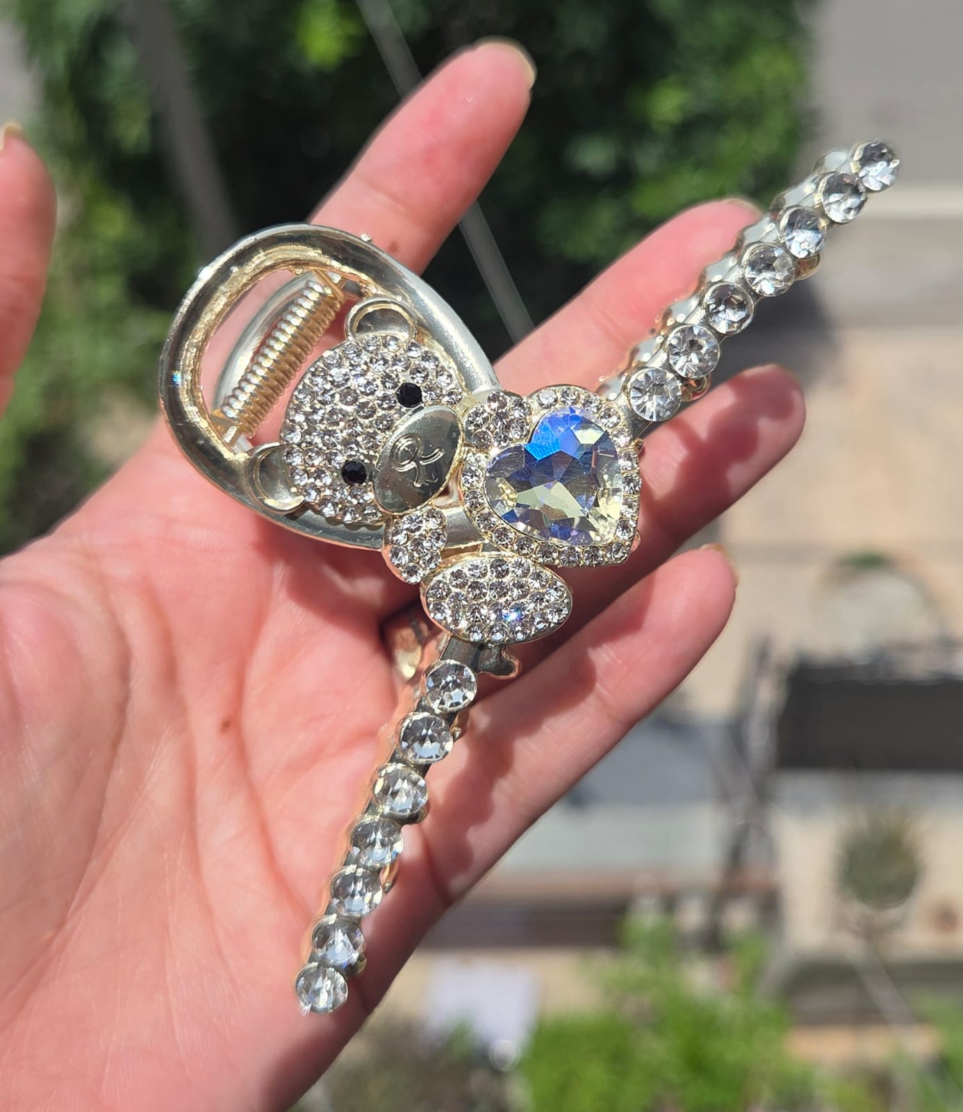 Anti-tarnish gold metal hair clutcher with rhinestone teddy bear and iridescent crystal heart design.