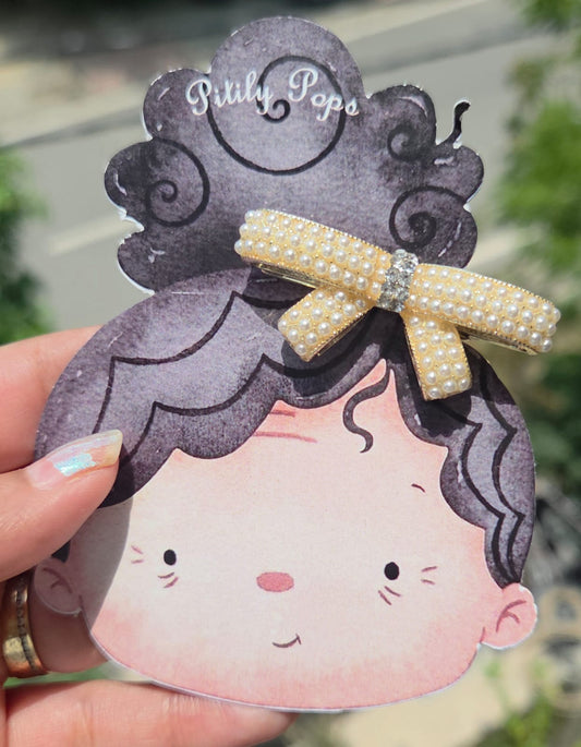 Handmade pearl hair bow clip with a sparkly rhinestone center band by Pitily Pops.
