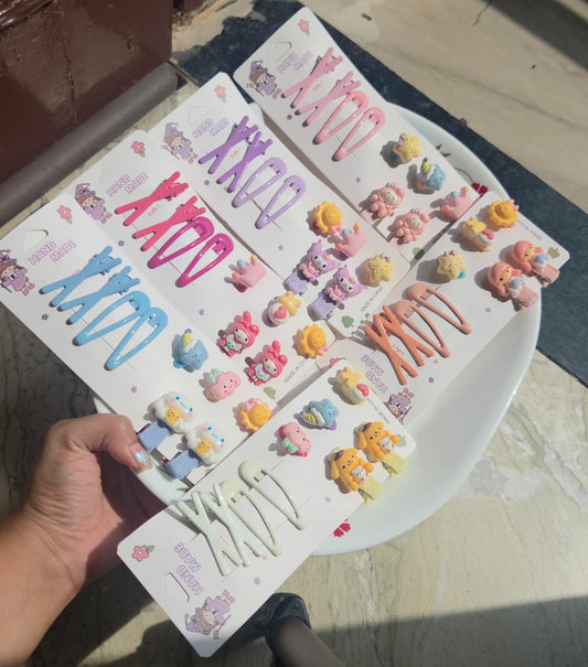 Six colorful pastel handmade hair clip cards featuring blue purple pink orange and white snap clips with cute cartoon charms.