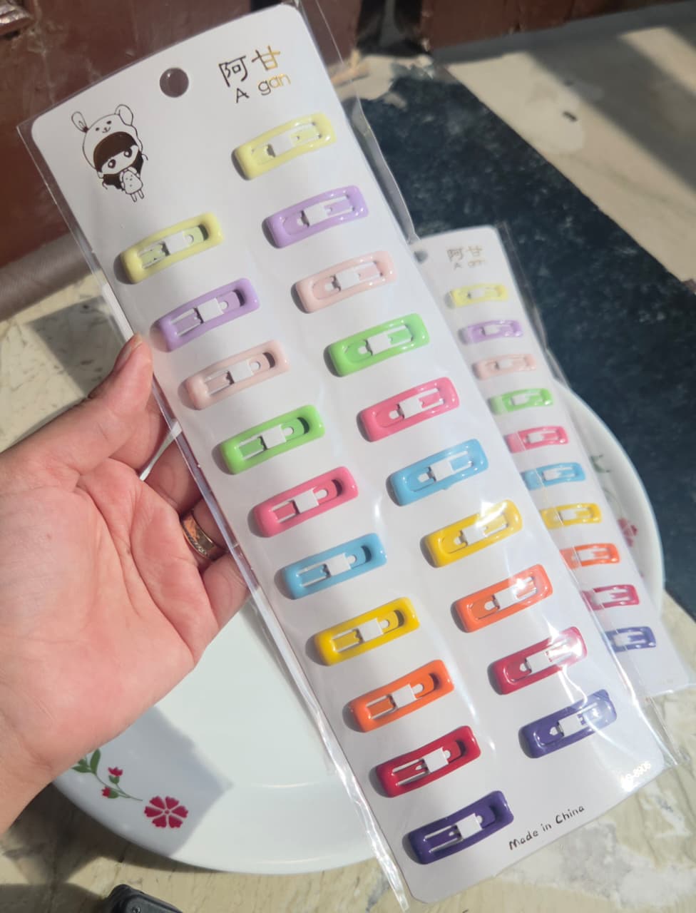 Pack of 20 colorful pastel matte tic tac snap hair clips arranged neatly on a white display card.