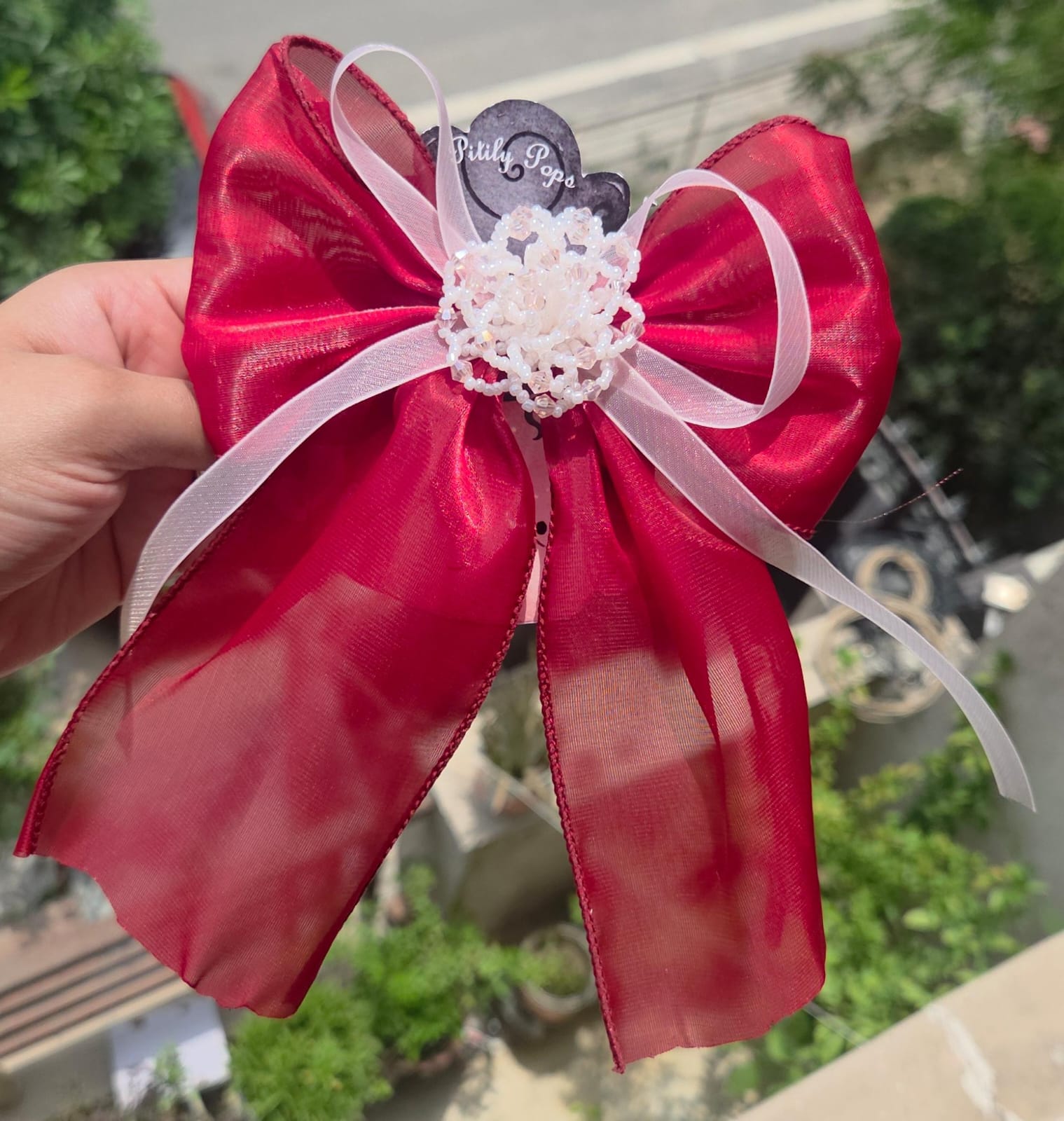 Handcrafted red color flower hair clips showing the delicate, lightweight layered fabric petals.