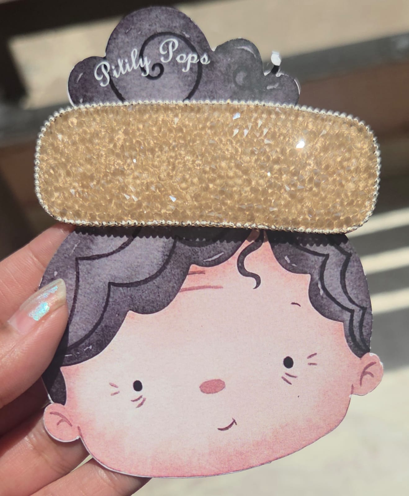 (Champagne Gold): Close-up view of a luxurious champagne gold sparkly tic tac hair clip, showcasing a dense layer of light-catching neutral crystals.