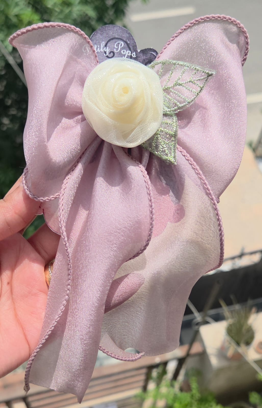 Dusty mauve sheer organza hair bow featuring a cream rose accent and alligator clip back