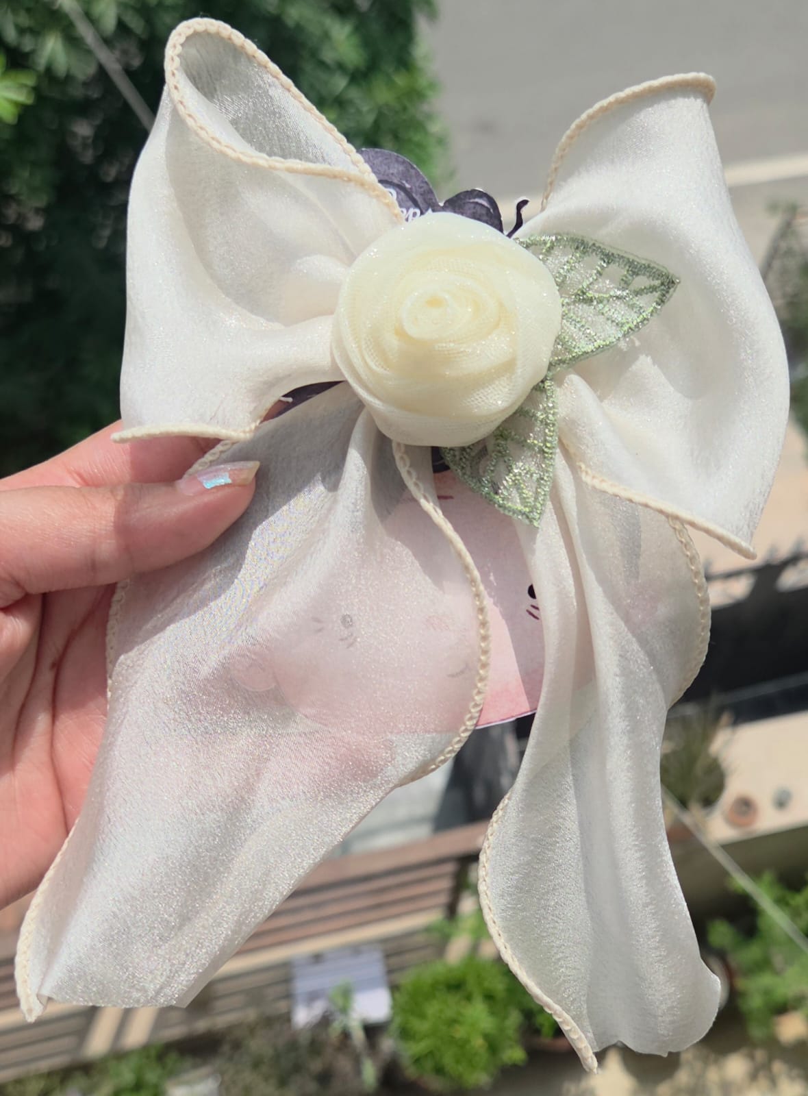 Off-white cream sheer hair bow with a matching rose accent and alligator clip back for weddings or formal hairstyles.
