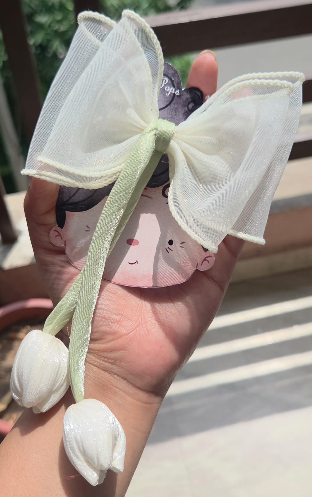 Elegant ivory white organza sheer hair bow featuring a delicate handmade white fabric tulip charm for bridal or everyday hairstyles.
