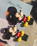 Pair of Mickey Mouse 3D character hair clips for young girls' hairstyles.
