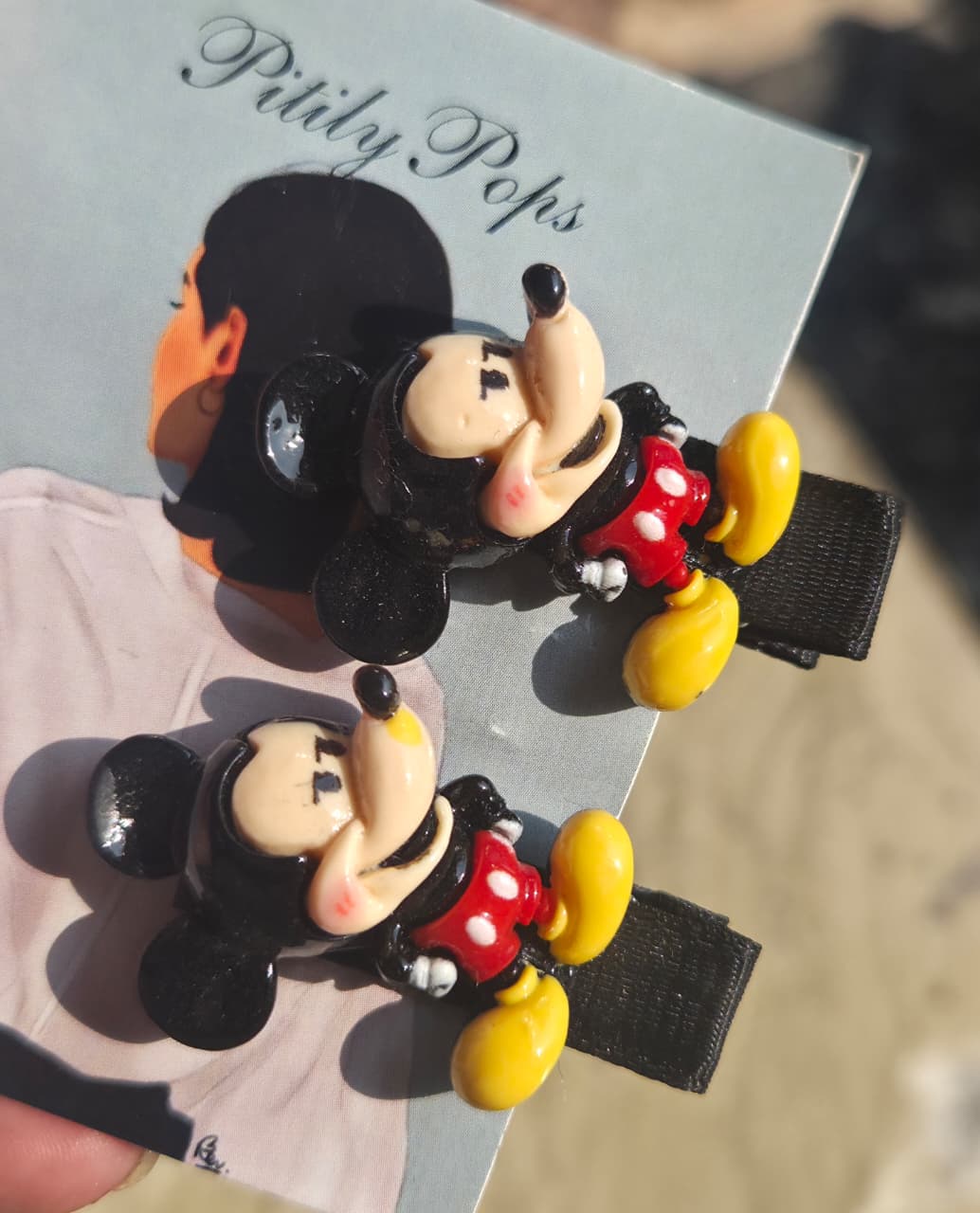 Pair of Mickey Mouse 3D character hair clips for young girls' hairstyles.