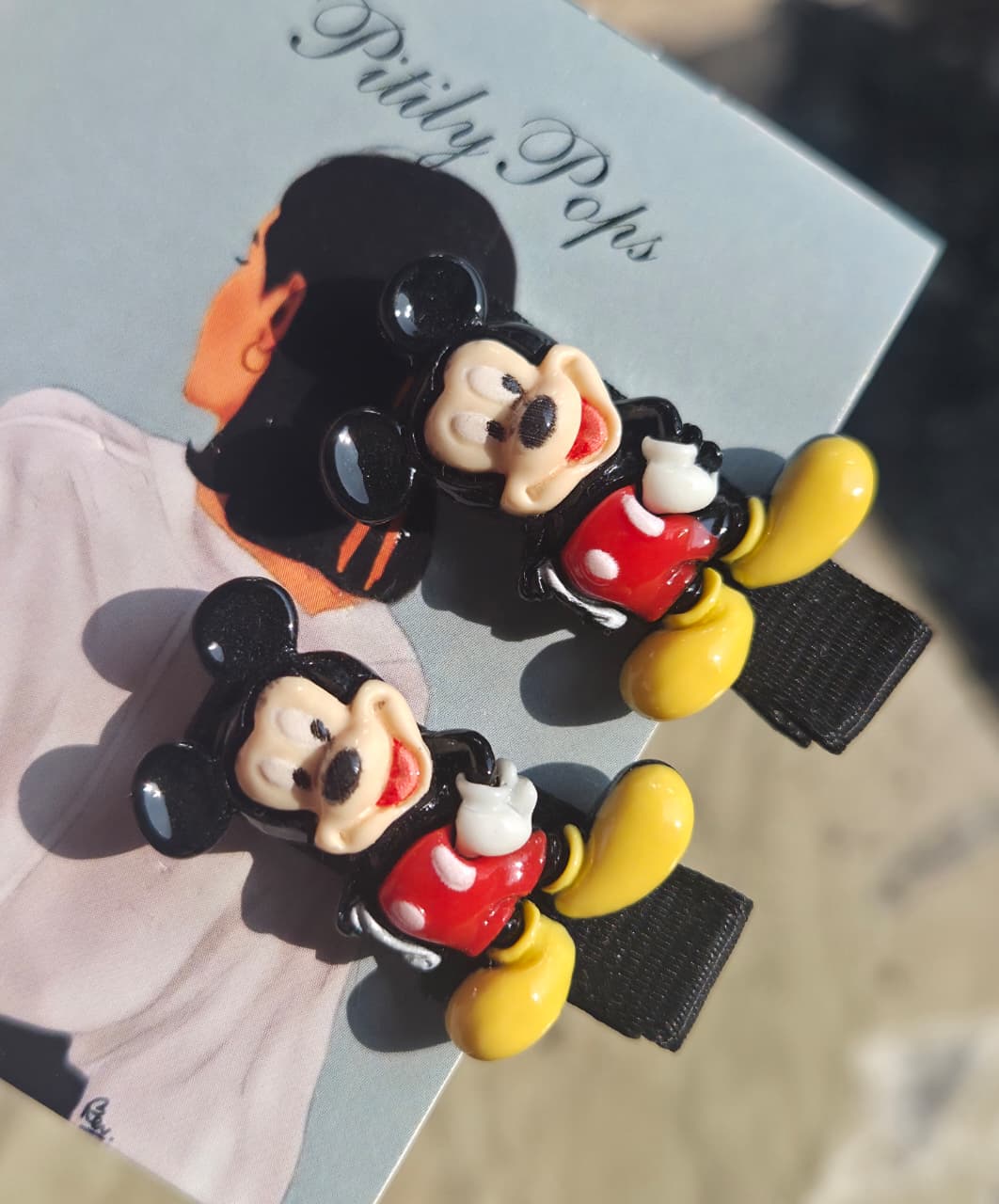 matching pair of Disney-inspired hair accessories featuring one Mickey Mouse clip and one Minnie Mouse clip side-by-side.