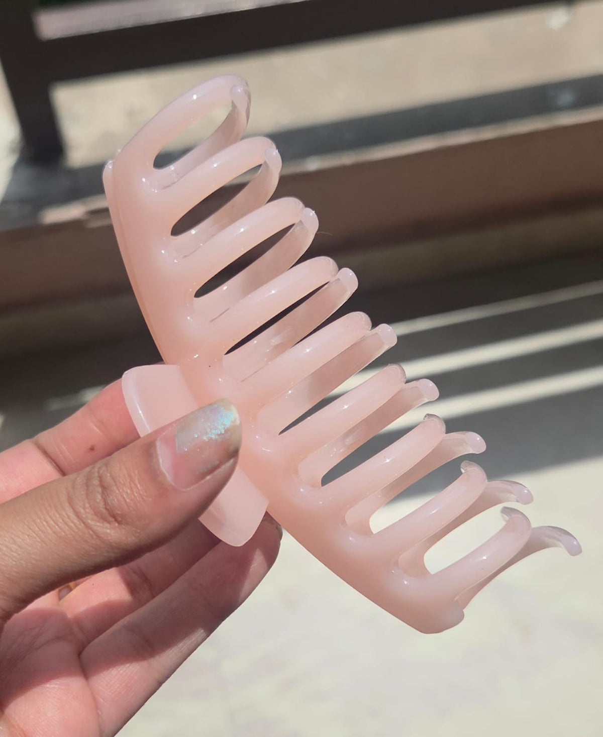 Close-up of a durable minimalist resin claw clip for secure hairstyles and updos.
