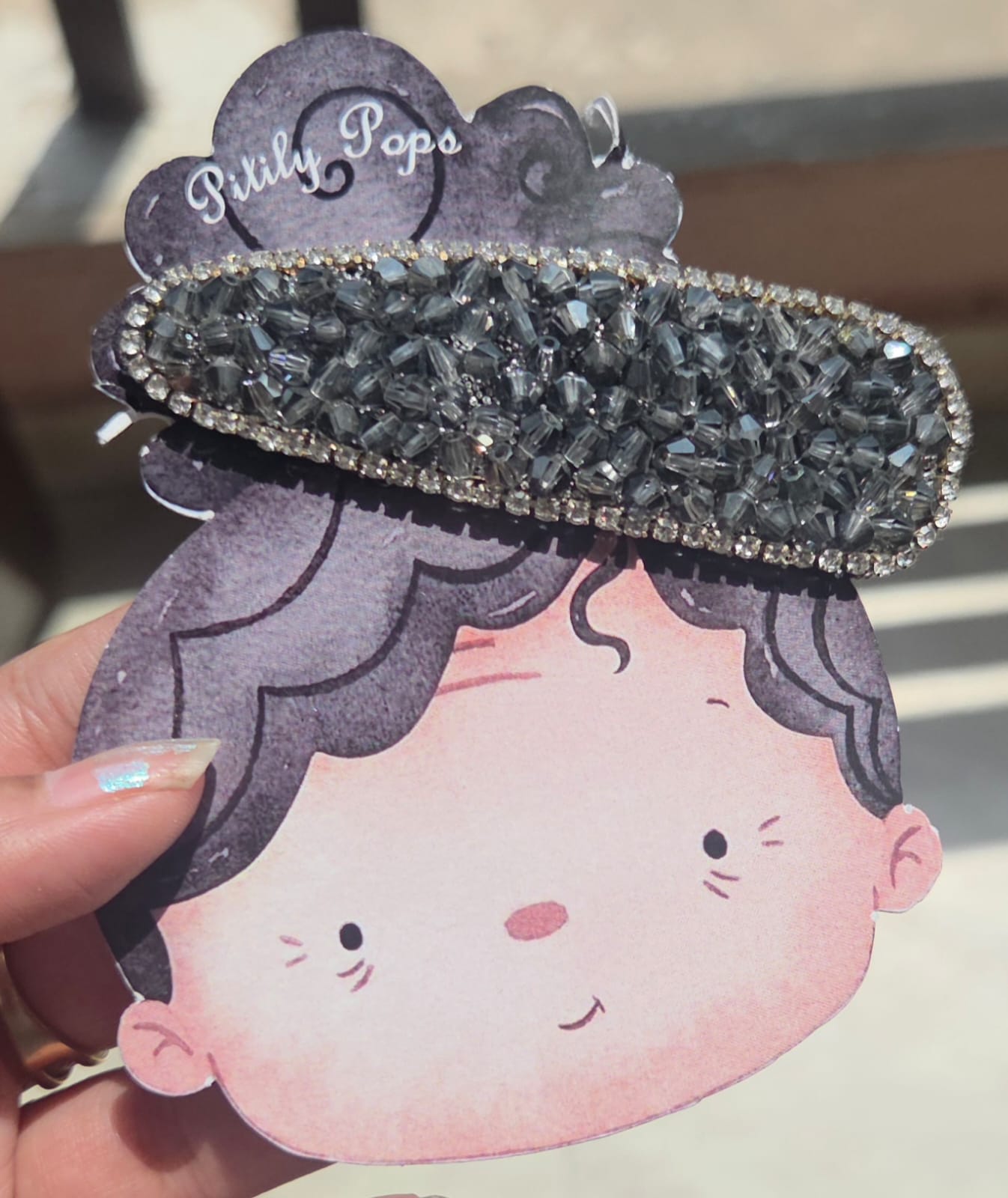 Shimmering dark grey charcoal black crystal encrusted alligator clip for modern hair styling.
