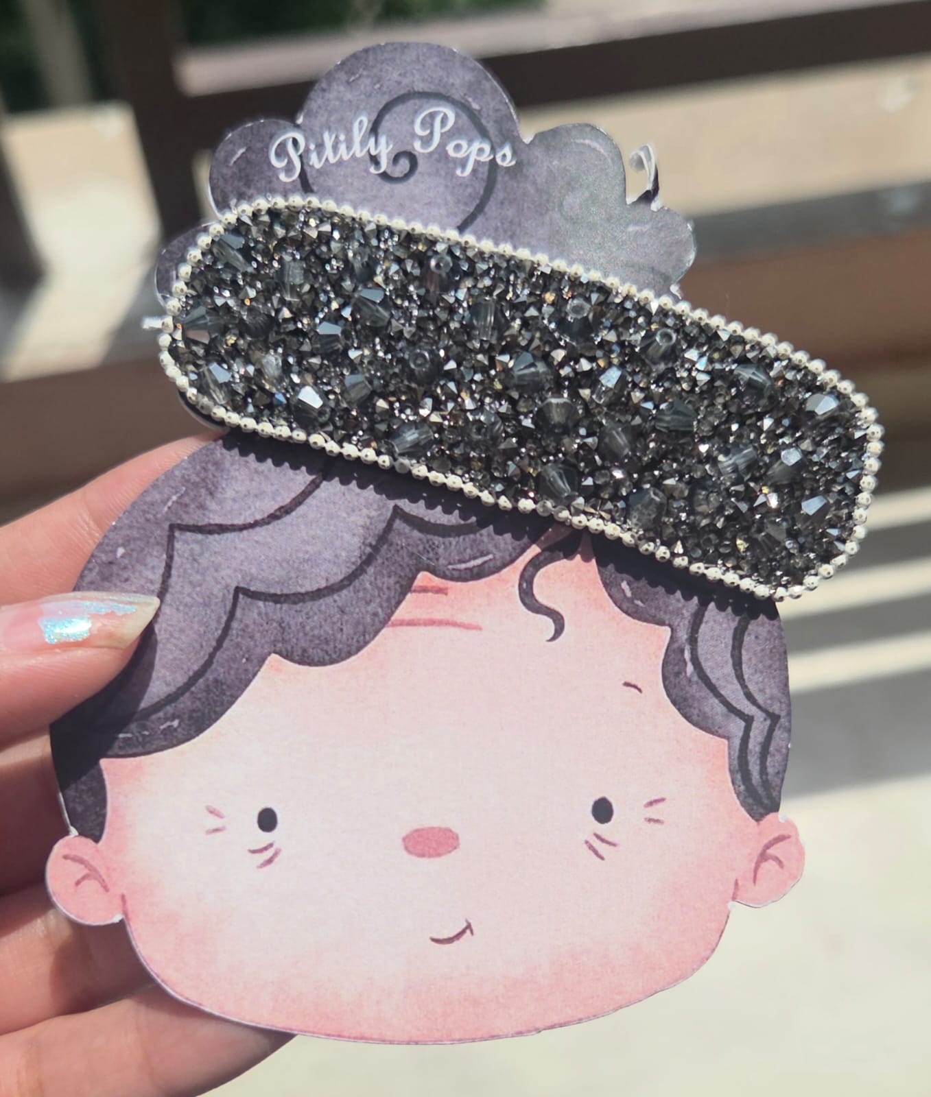 Glittery midnight black rhinestone snap hair barrette for edgy and gothic chic fashion styles.
