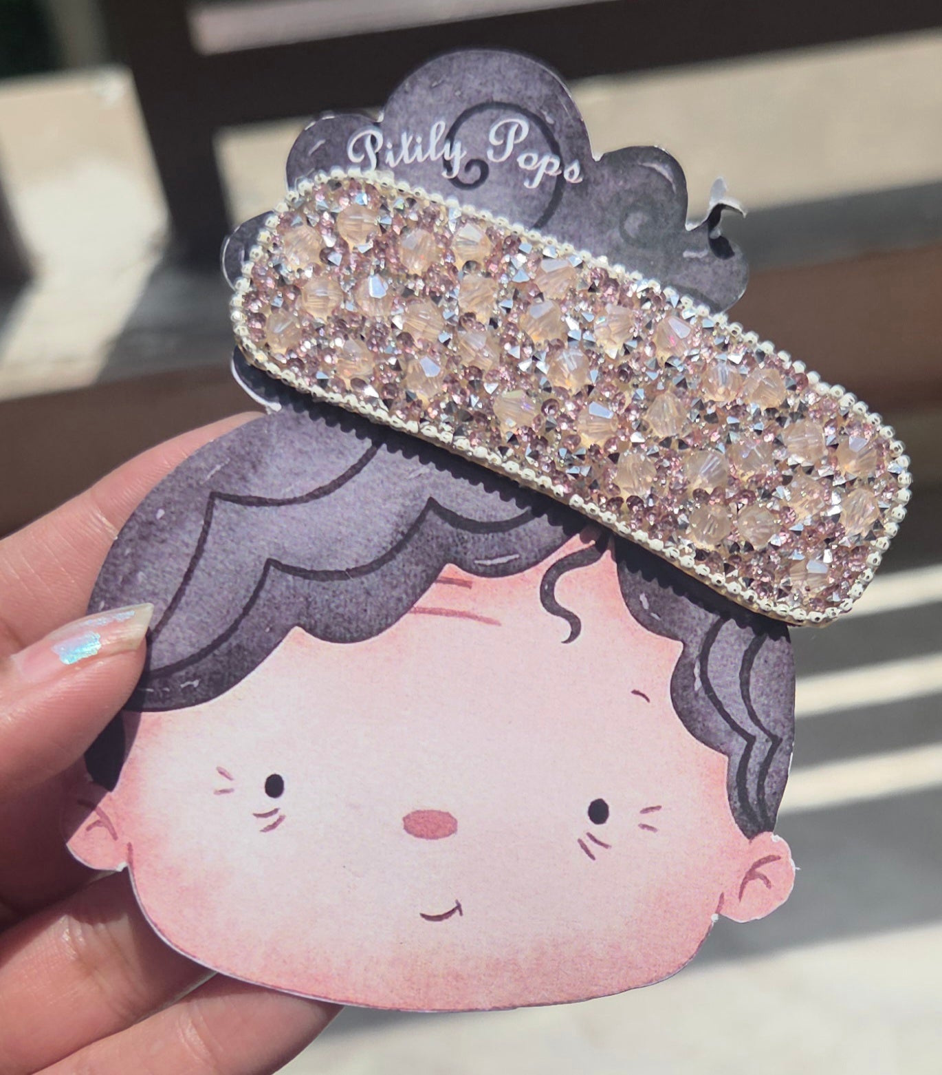 Close-up of a sparkling champagne gold rhinestone hair clip barrette for elegant hairstyles.
