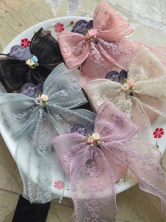 Group of 5 vintage lace embroidered hair bow clips in black, pink, cream, lavender, and sage green with mini satin roses
