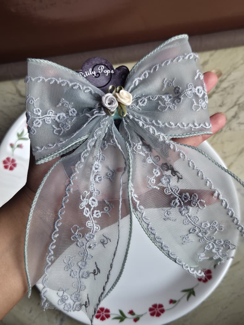 Dusty sage green sheer lace hair bow clip with subtle floral embroidery for coquette aesthetic
