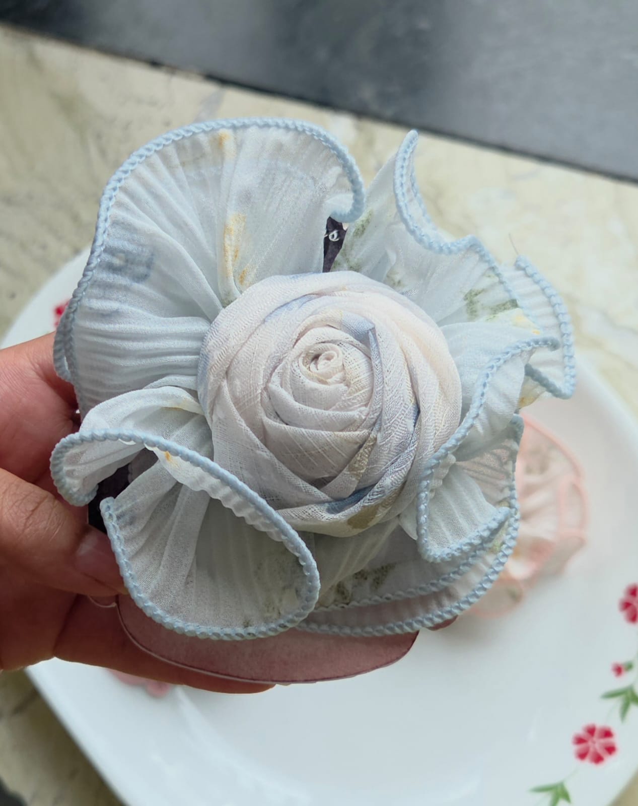 Light powder blue rosette flower hair pin accessory for women.