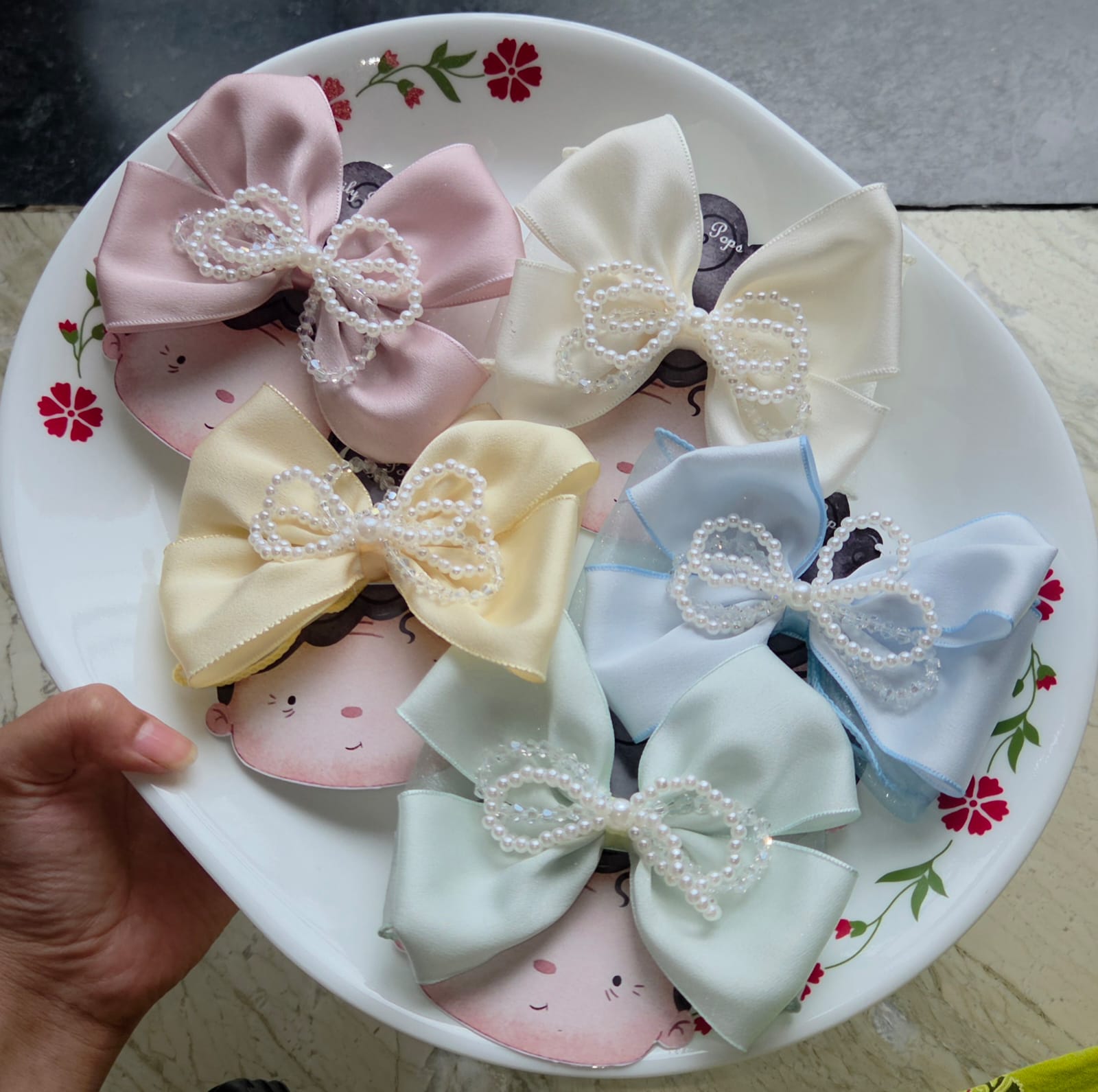 Set of 5 pastel satin bow hair clips in pink, ivory, yellow, blue, and mint green with pearl beaded accents