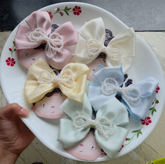 Set of 5 pastel satin bow hair clips in pink, ivory, yellow, blue, and mint green with pearl beaded accents