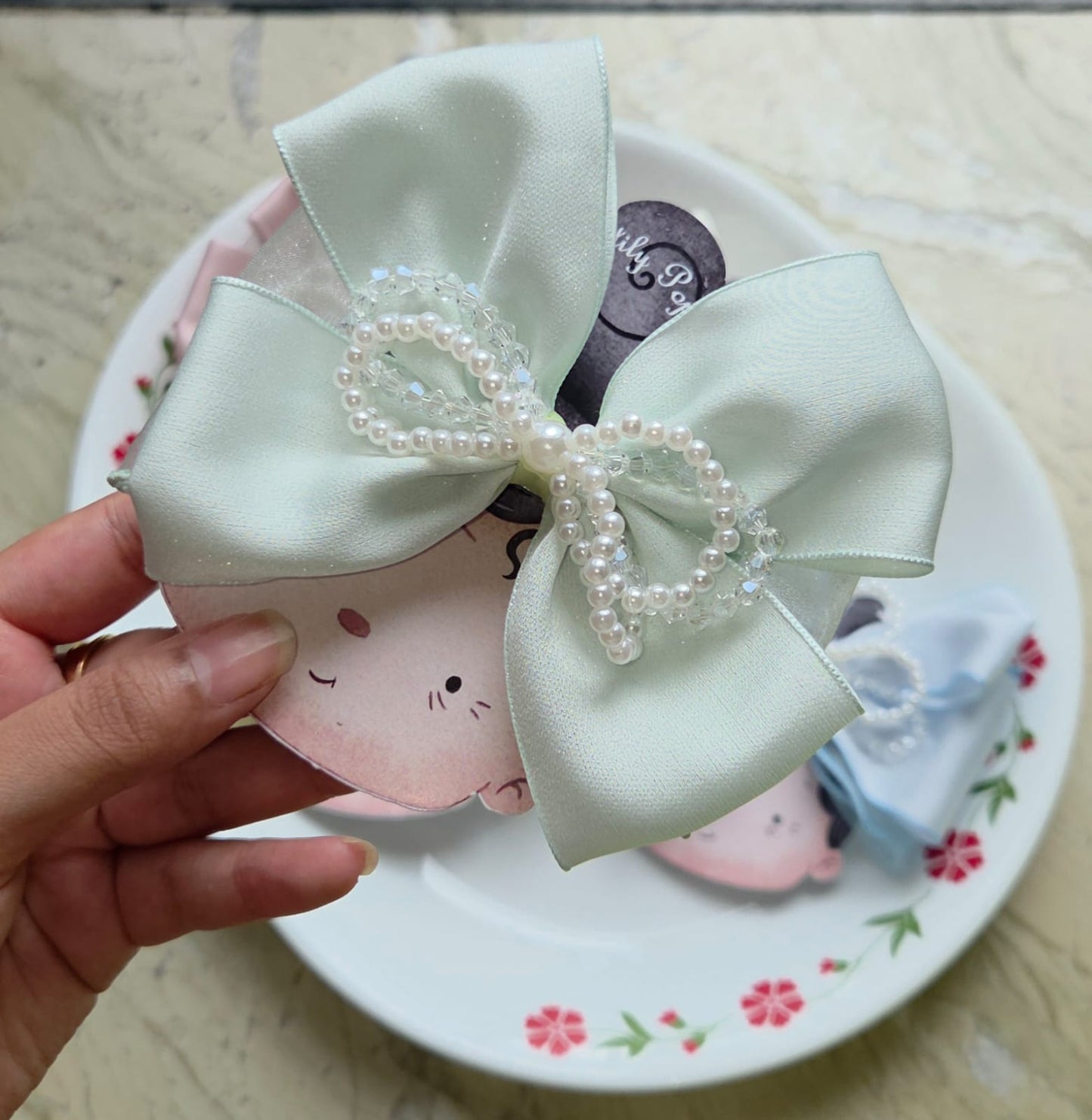 Mint green satin pearl bow hair clip for elegant half-up hairstyles