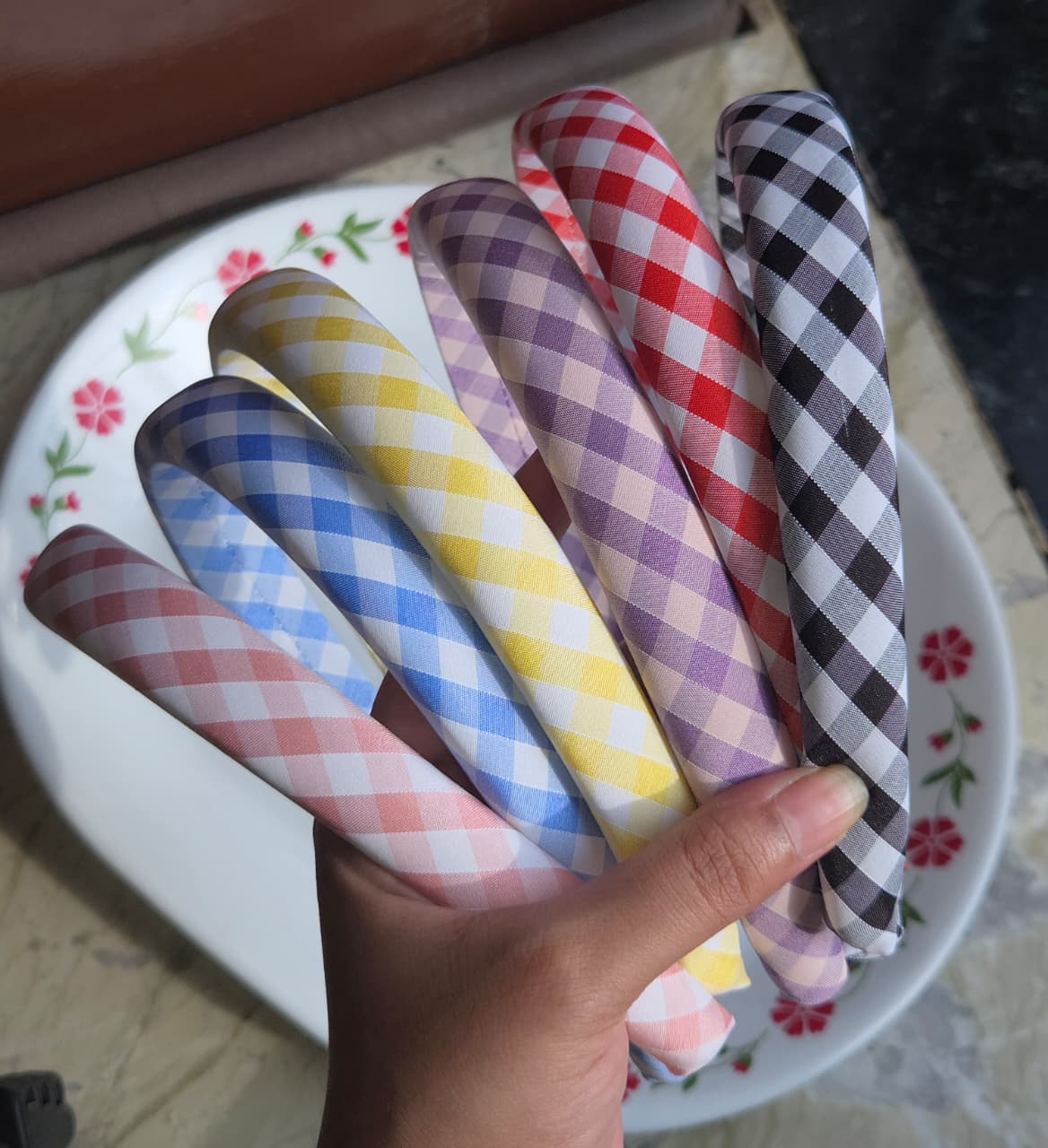    Stacked plaid fabric hairbands showing classic gingham checkered pattern details
