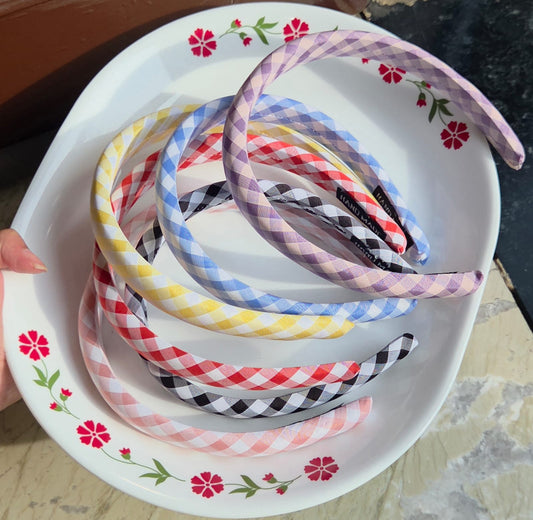    Collection of gingham checked fabric headbands in pink blue yellow purple red and black

