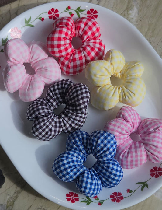    Six flower shaped gingham hair scrunchies in red pink yellow black and blue plaid patterns

