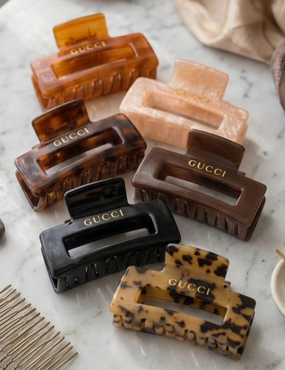   > "Group of 6 luxury style rectangular hair claw clips in tortoiseshell, black, blush pink, brown, plum, and black lace patterns."
