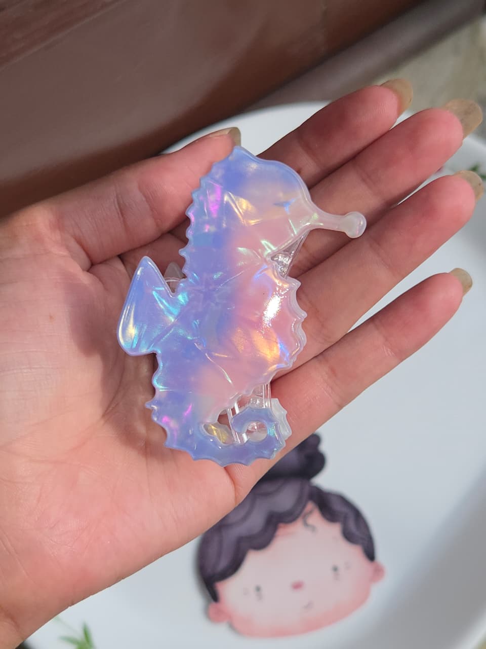    Light blue and pink iridescent seahorse hair clip accessory