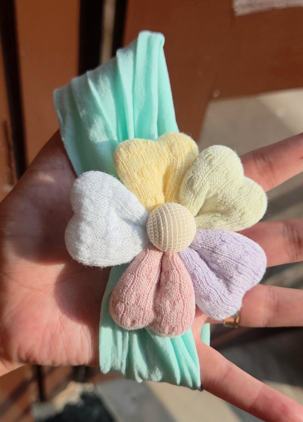   Mint green stretchable baby hairband with a cute fabric flower for newborns and toddlers
