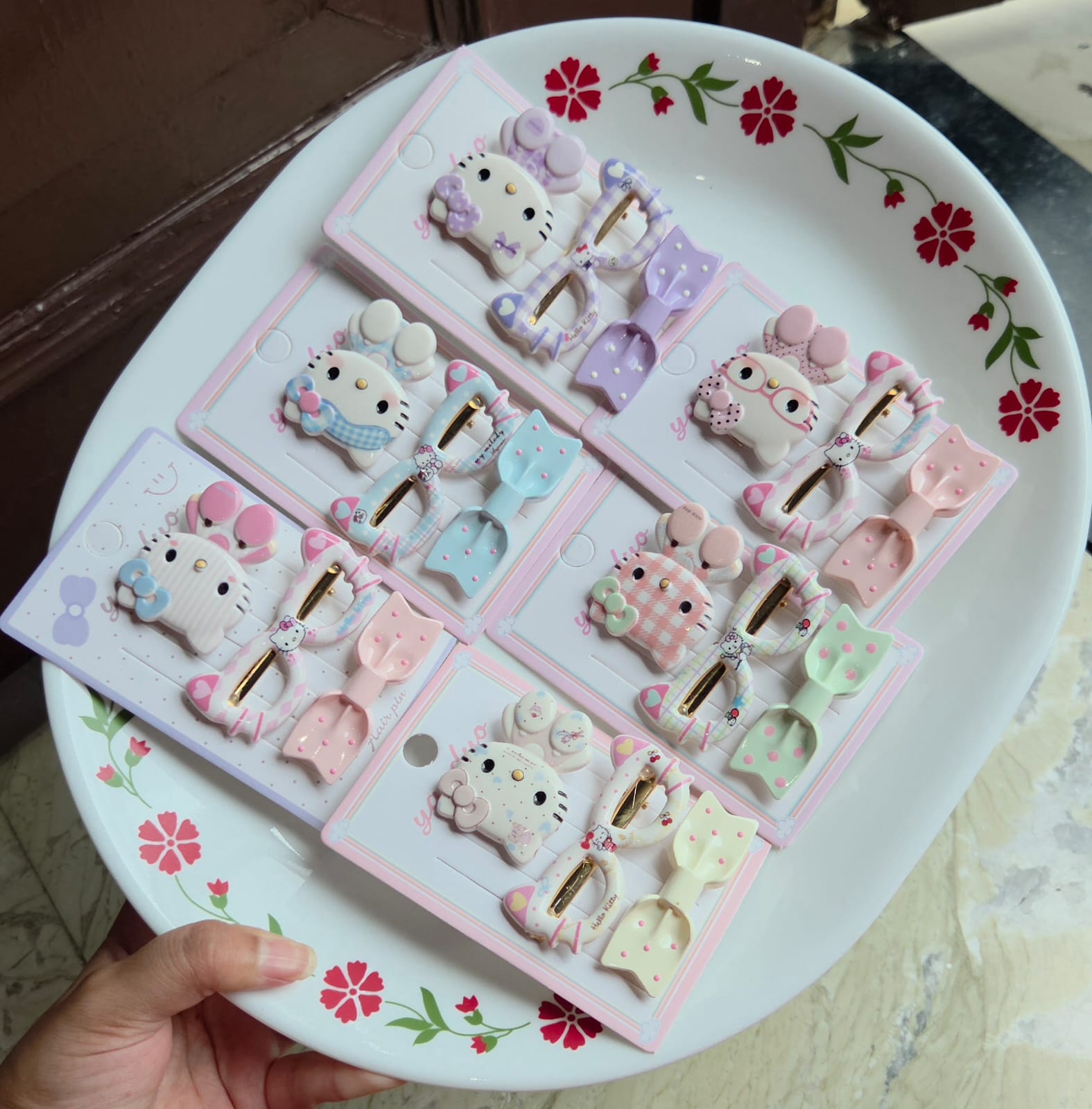    Six cards of 3-piece cute character hair clip sets in pastel purple, blue, pink, green, peach, and cream arranged on a tray.
