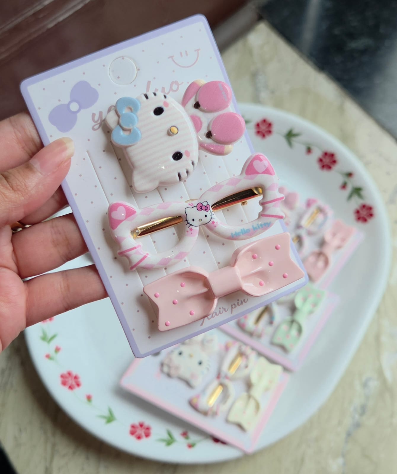    Soft peach-pink character hair accessory set with matching printed oval clip and bow pin.