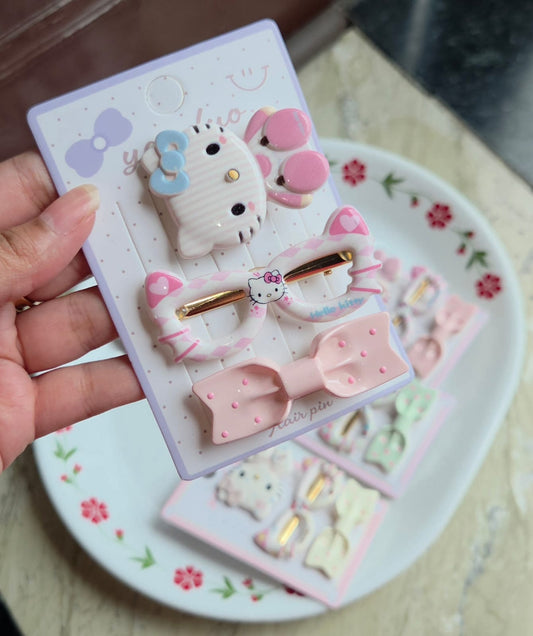    Soft peach-pink character hair accessory set with matching printed oval clip and bow pin.