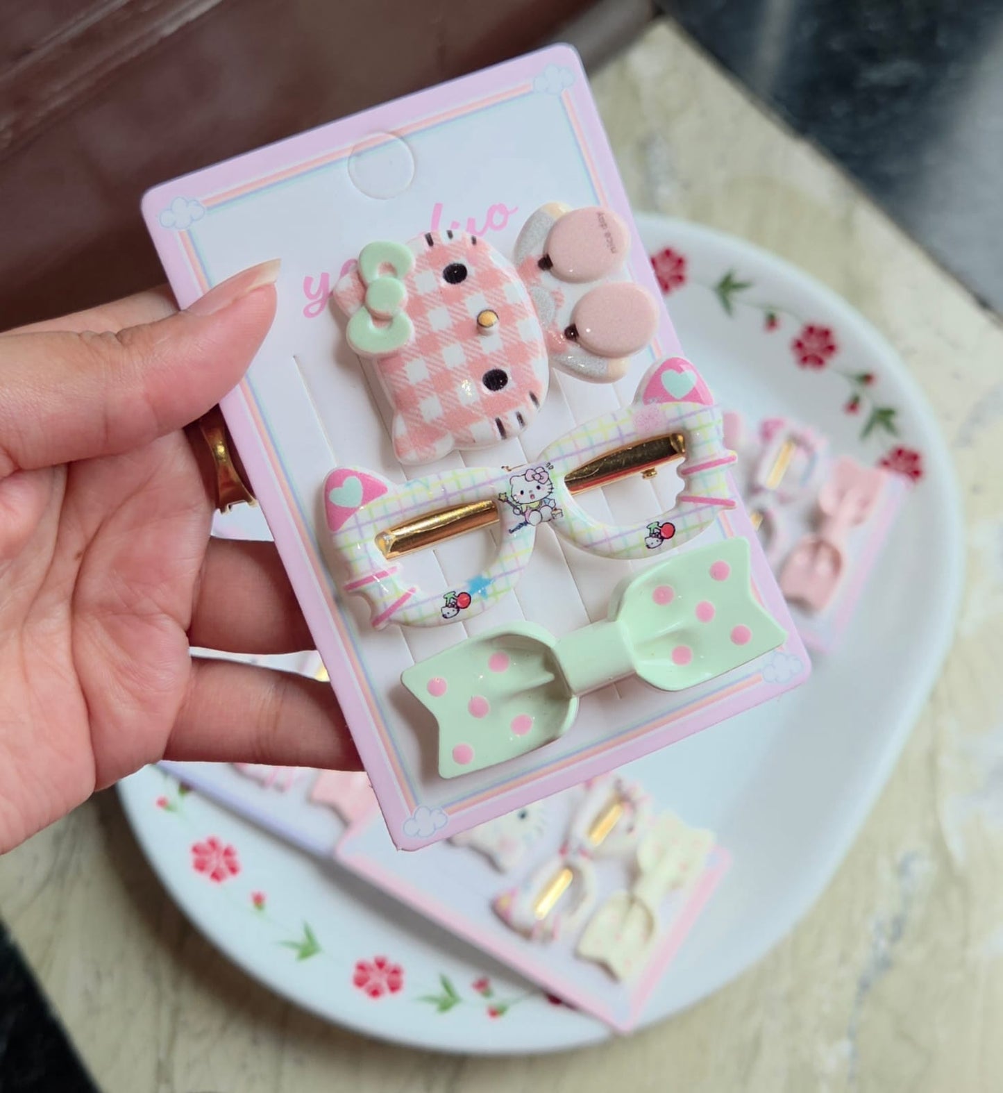    Sage green 3-piece hair clip card with checkered character face pin and mint polka dot bow.
