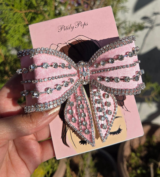 Luxury pink rhinestone hair bow clip with sparkly crystal detailing and buckle closure

