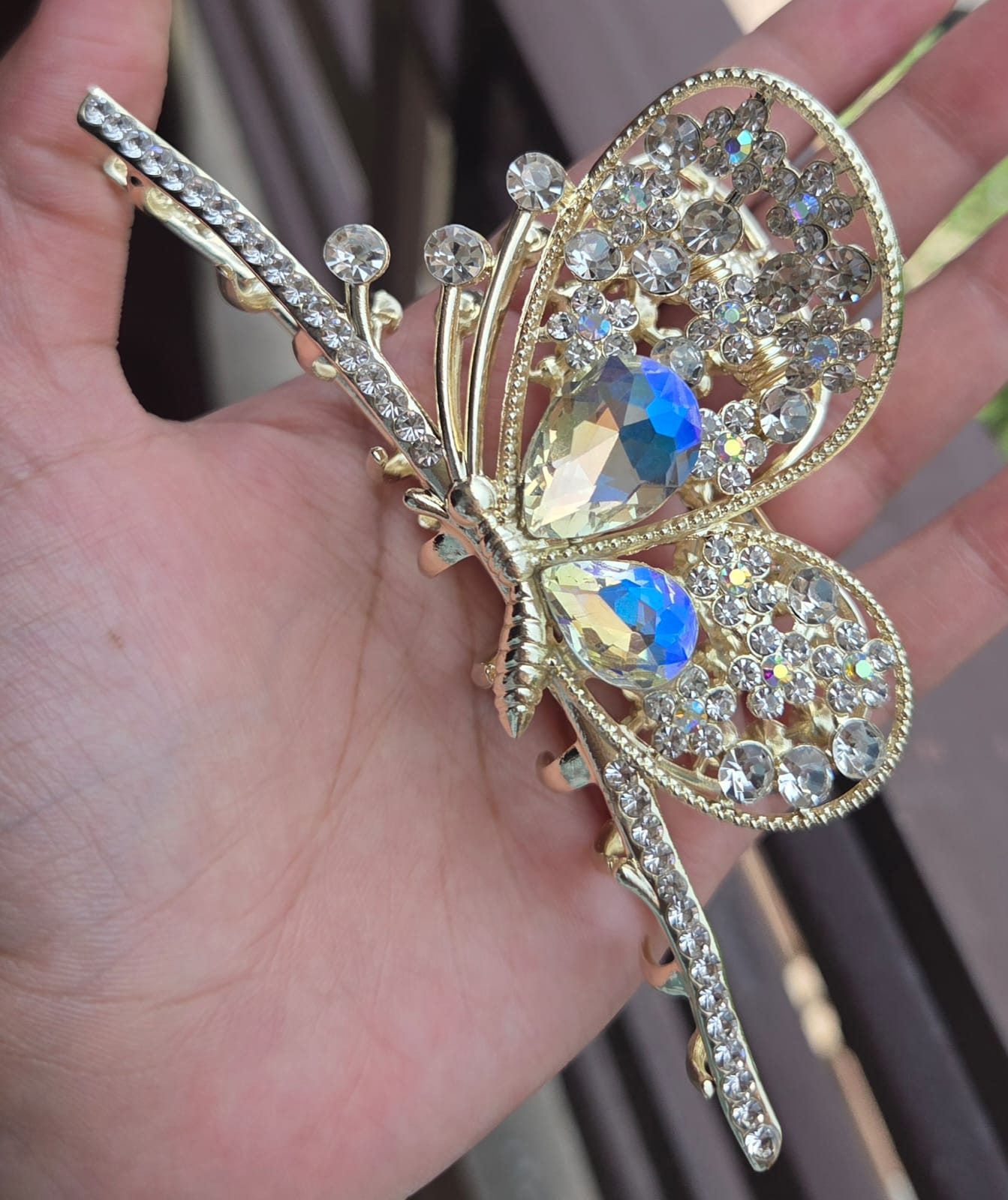 Luxury stone-studded butterfly metal hair clutcher featuring iridescent holographic crystals and a strong-hold grip.