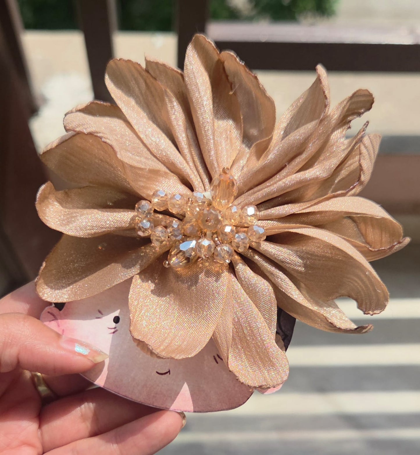 Shimmering champagne gold silk-textured flower clip with an elegant neutral bead center, perfect for weddings.