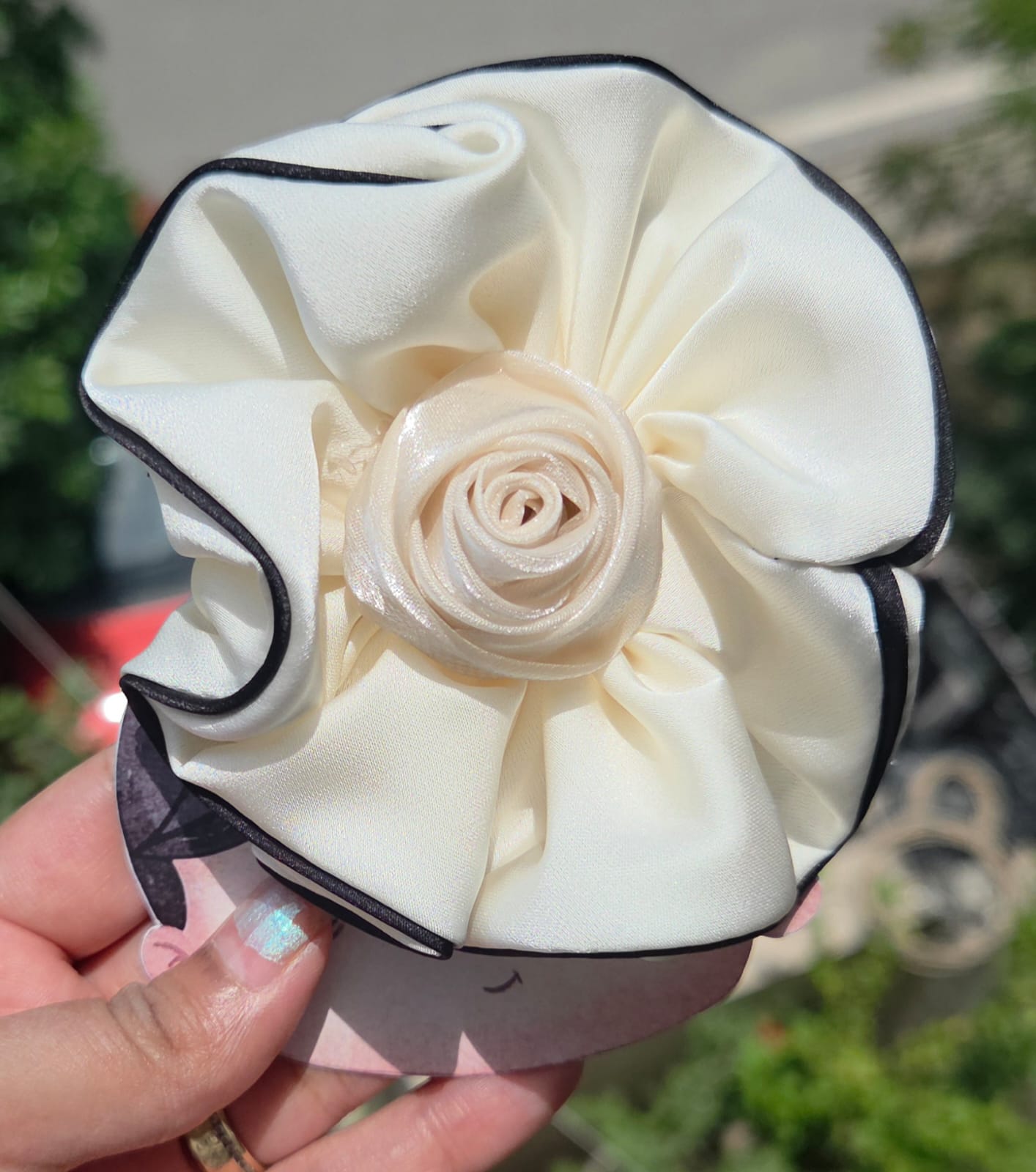 Off-white cream satin flower hair clip with black piped edges, perfect bridal or bridesmaid hair accessory.