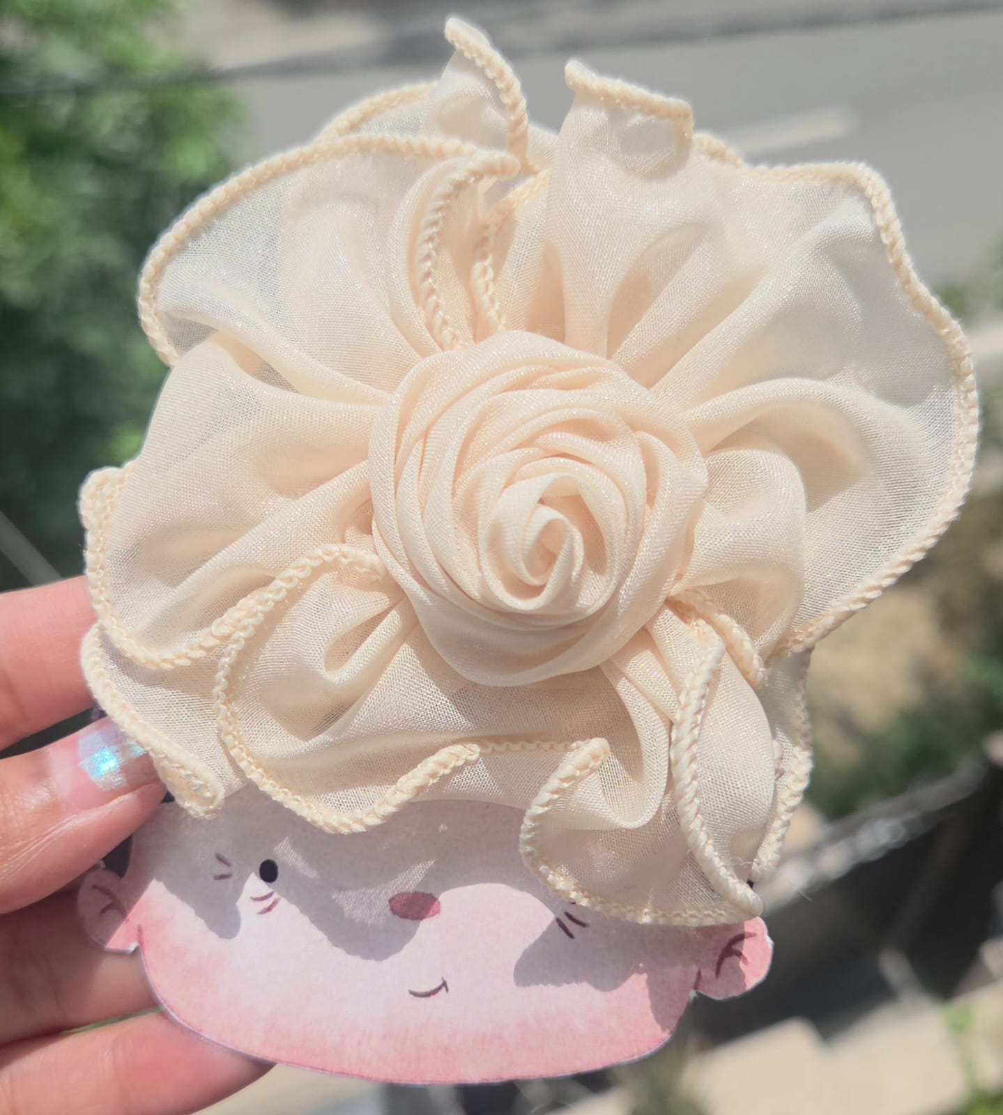 Elegant cream fabric flower hair clip with a secure alligator clip backing for everyday styling.