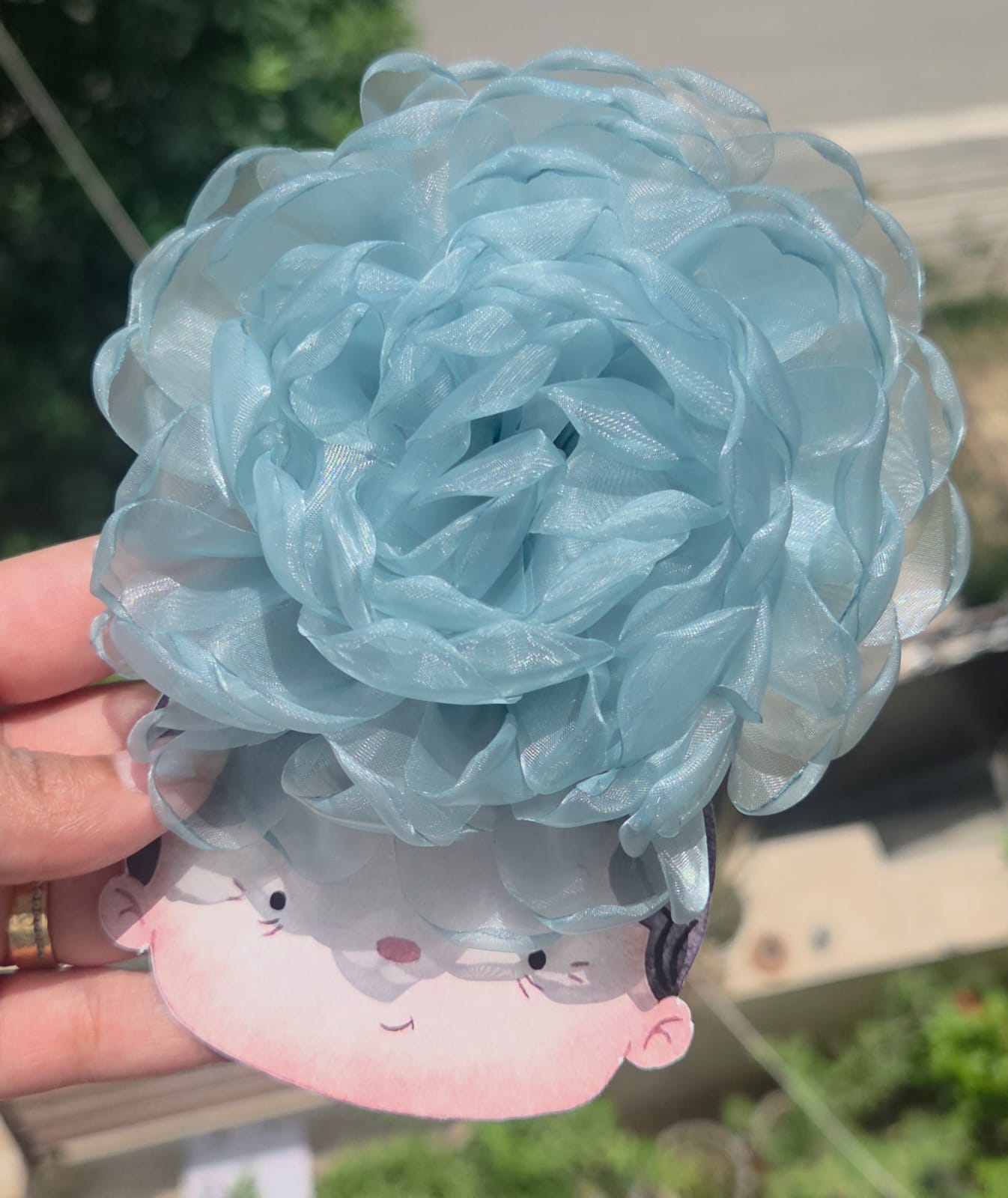 Light pastel sky blue sheer organza floral hair clip with secure metal backing.