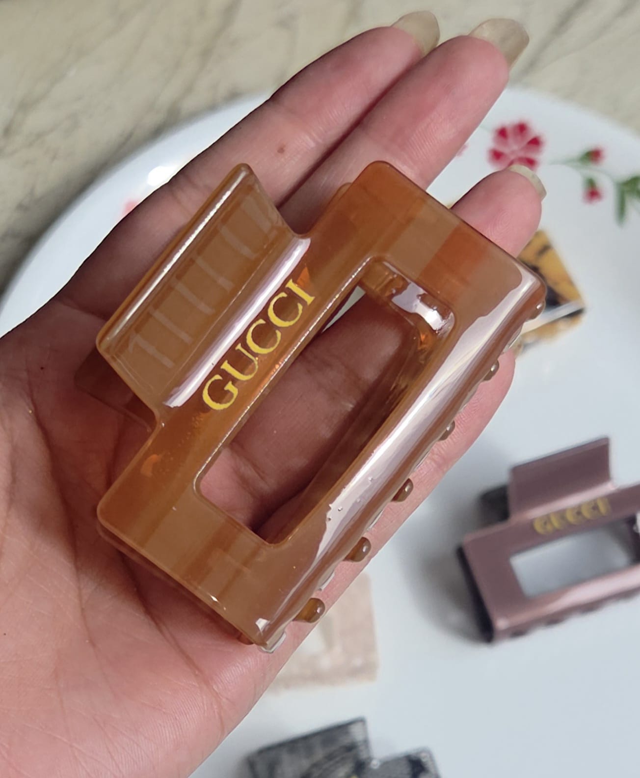    > "Translucent amber honey brown rectangular hair clutch clip with strong inner teeth."
