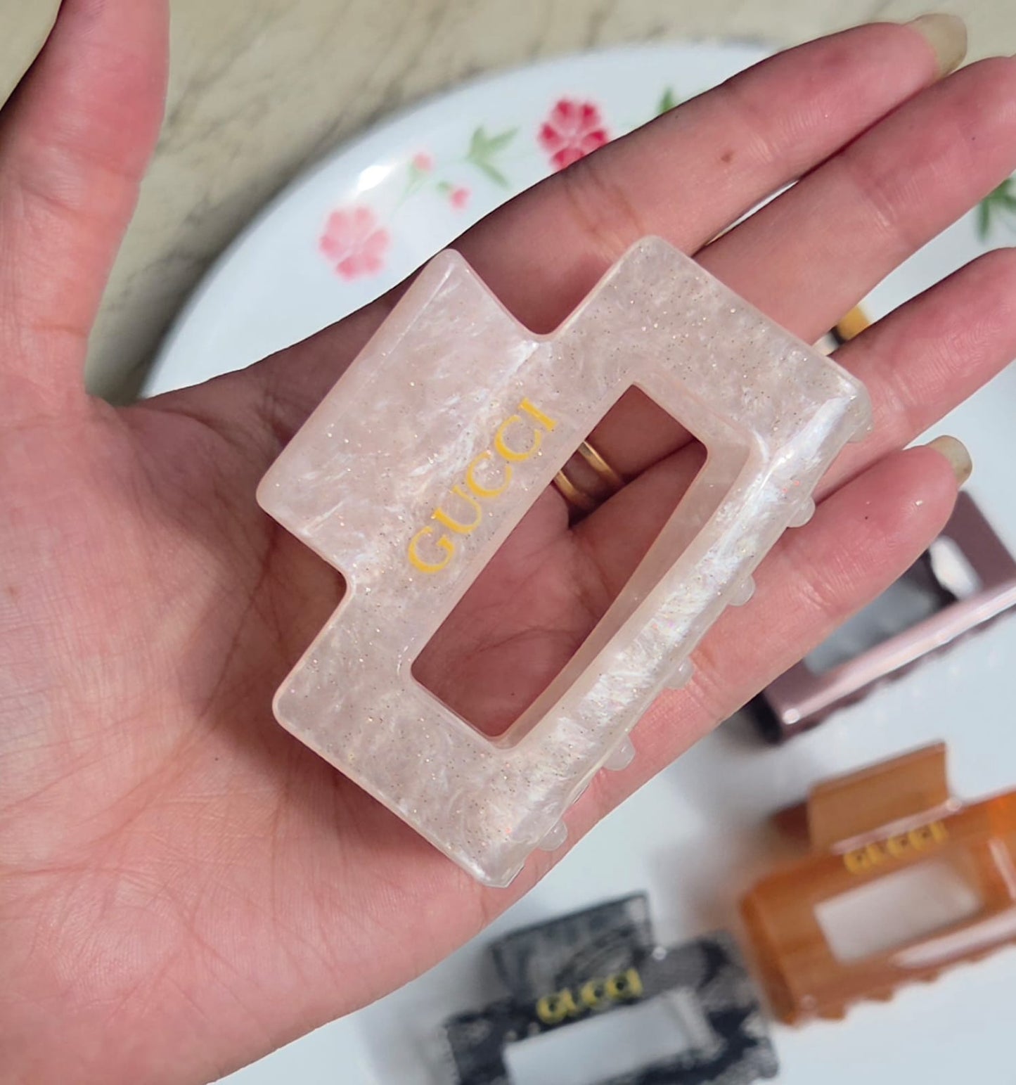    > "Soft blush pink pearl shimmer resin rectangular hair claw clip for women."
