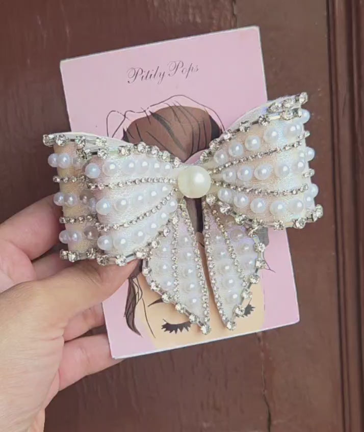 Handcrafted white iridescent bow barrette with rows of faux pearls rhinestone chain trim and large center pearl for bridal wedding hair
